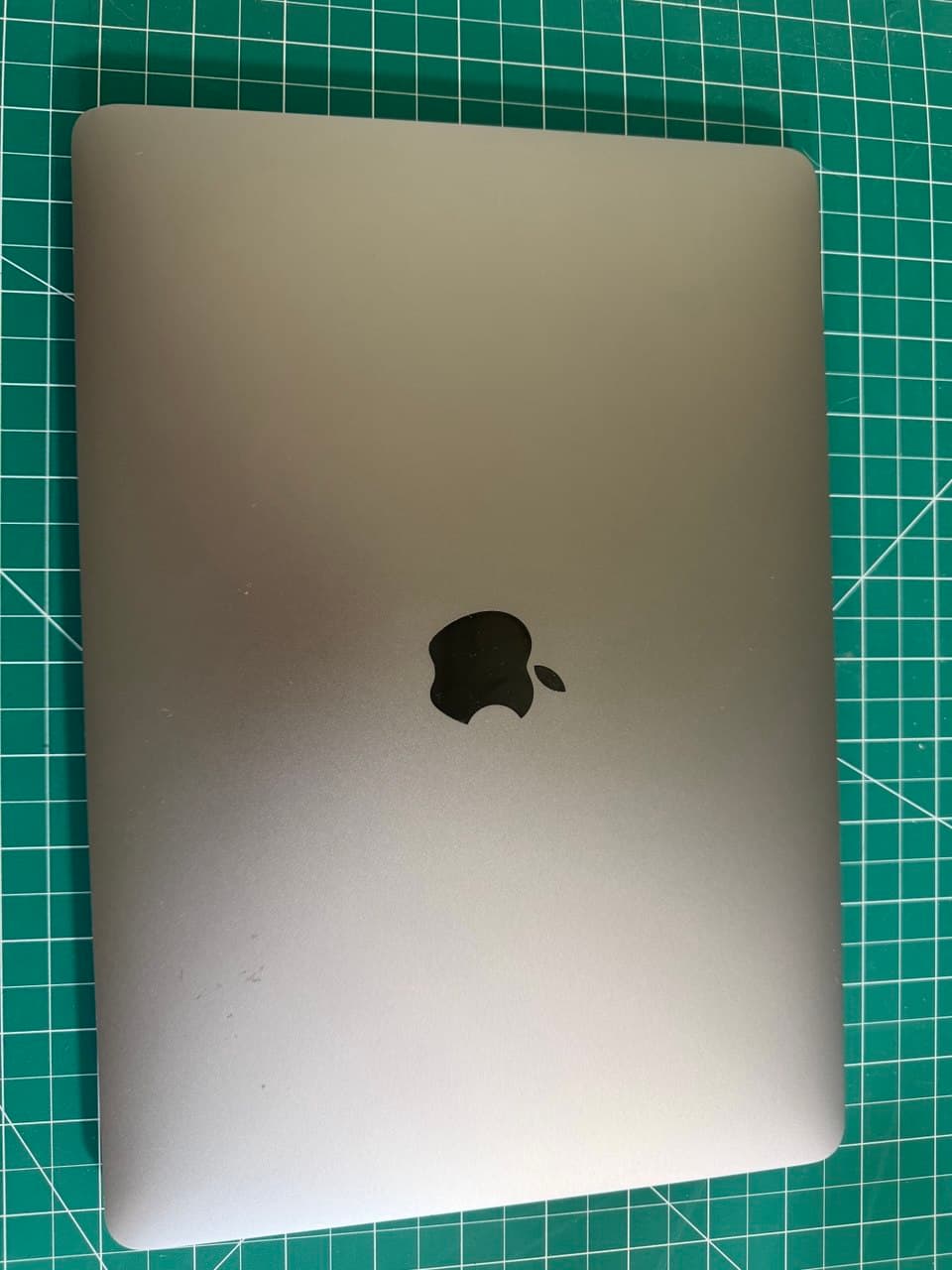 Space-gray M1 MacBook Air, lid closed, top-down