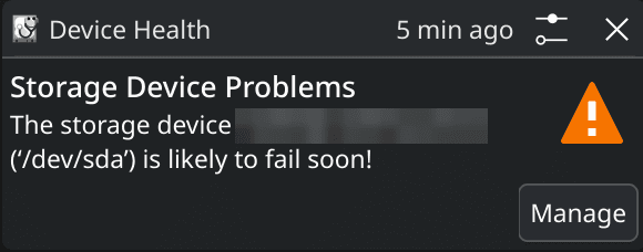 A desktop warning: Storage Device Problems. The storage device is likely to fail soon. The drive model is blurred.