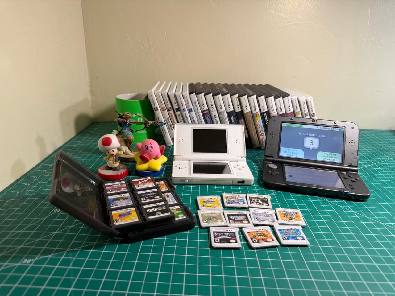 The full Nintendo DS & 3DS collection — both consoles, amiibo, and the game library laid out