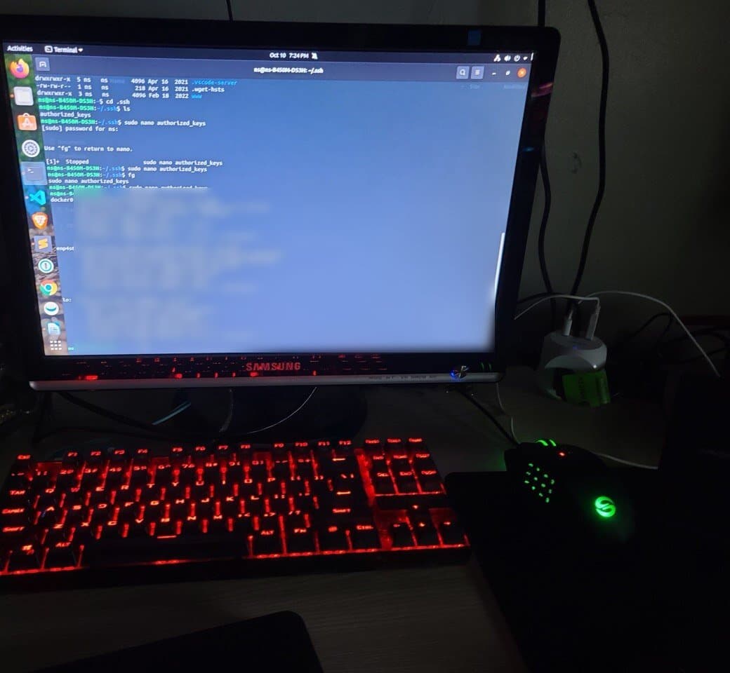 An Ubuntu desktop with a terminal open, above a red-backlit keyboard and a green-lit mouse
